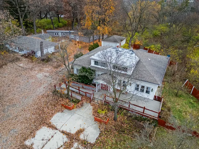 an aerial view of a house with a yard and trees