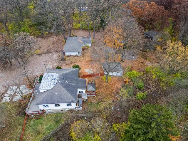 an aerial view of a house with a yard