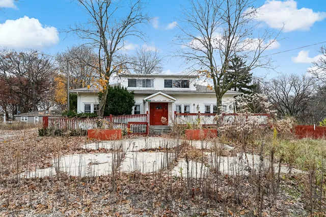 a view of house with yard and sitting area