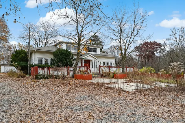 a view of a house with a yard patio and fire pit