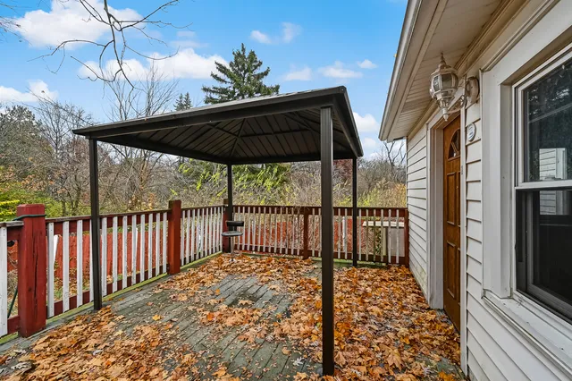 a view of balcony with wooden floor and fence