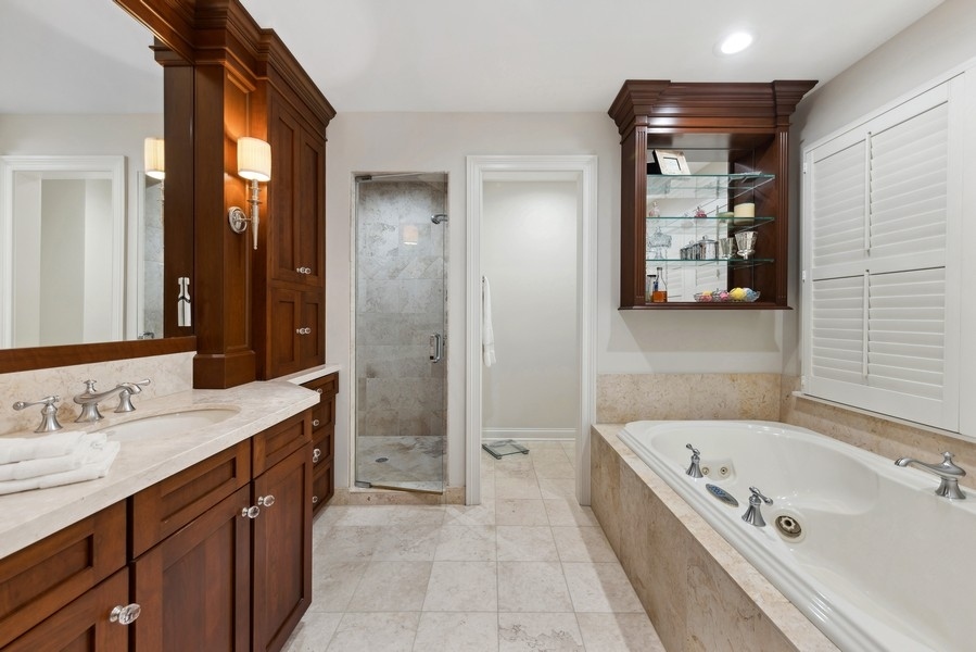 312 Forest Road Hinsdale, IL 60521 - Photo 23 of 49 a bathroom with a tub a double vanity sink and mirror
