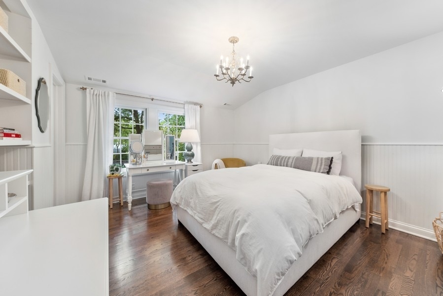 312 Forest Road Hinsdale, IL 60521 - Photo 30 of 49 a large bed sitting in a bedroom next to a window and a chandelier