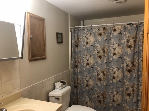15 Primrose Road Billerica, MA 01821 - Photo 7 of 26 a white toilet sitting next to a shower curtain