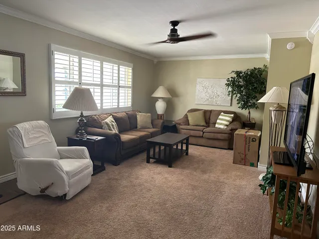 a view of a house with backyard and a tree