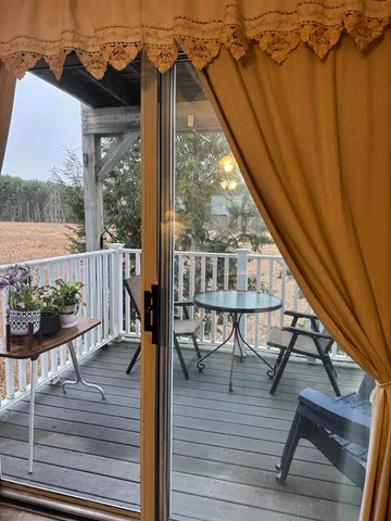 a view of a balcony with chairs