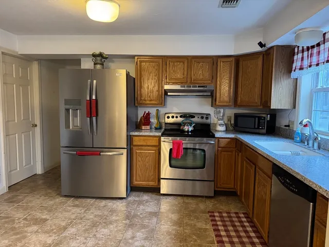 a kitchen with a refrigerator and a sink