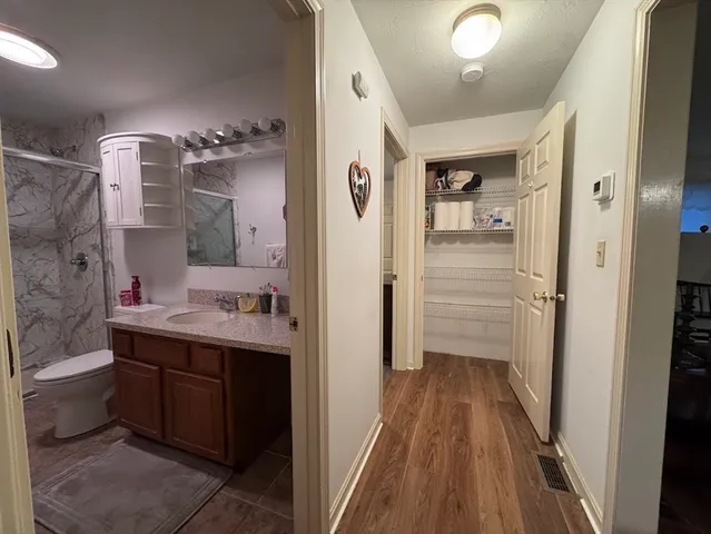 a bathroom with a sink a toilet and shower