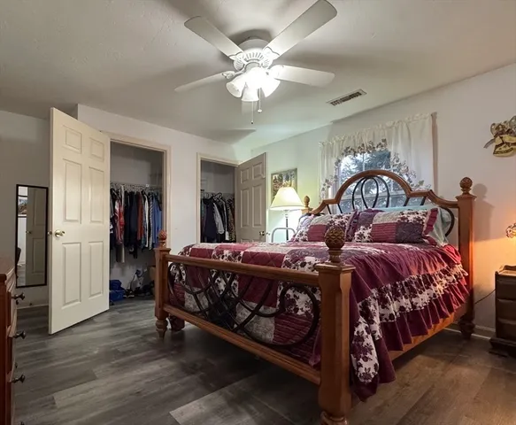 a bedroom with a bed and a ceiling fan