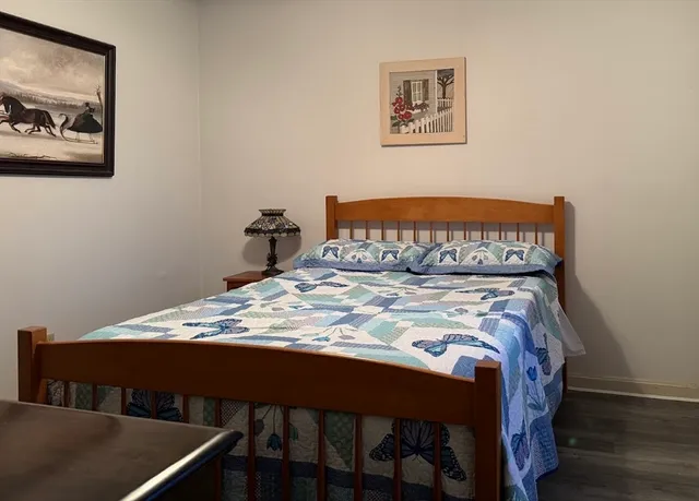 a bed sitting in a bedroom next to a small bathroom