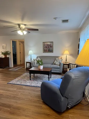 a living room with furniture and a lamp