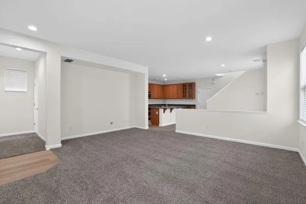 an empty room with a kitchen and a sink