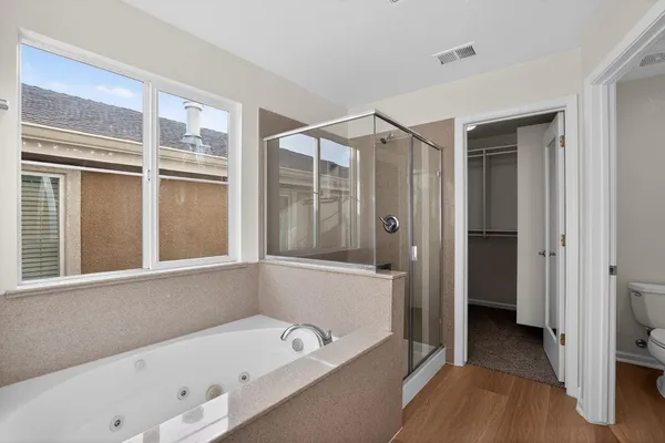 a bathroom with a bathtub and a shower