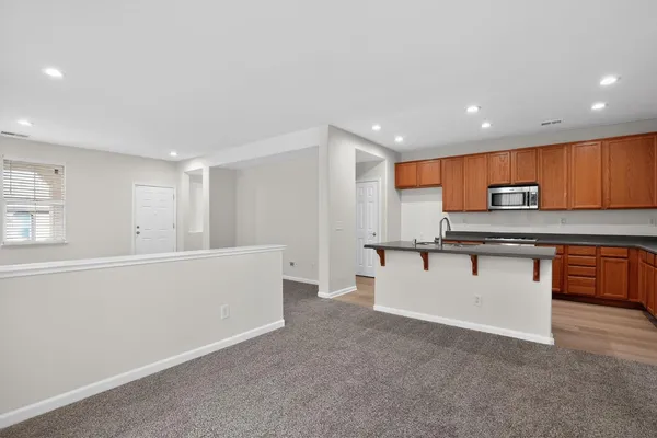 a view of kitchen with stainless steel appliances cabinets