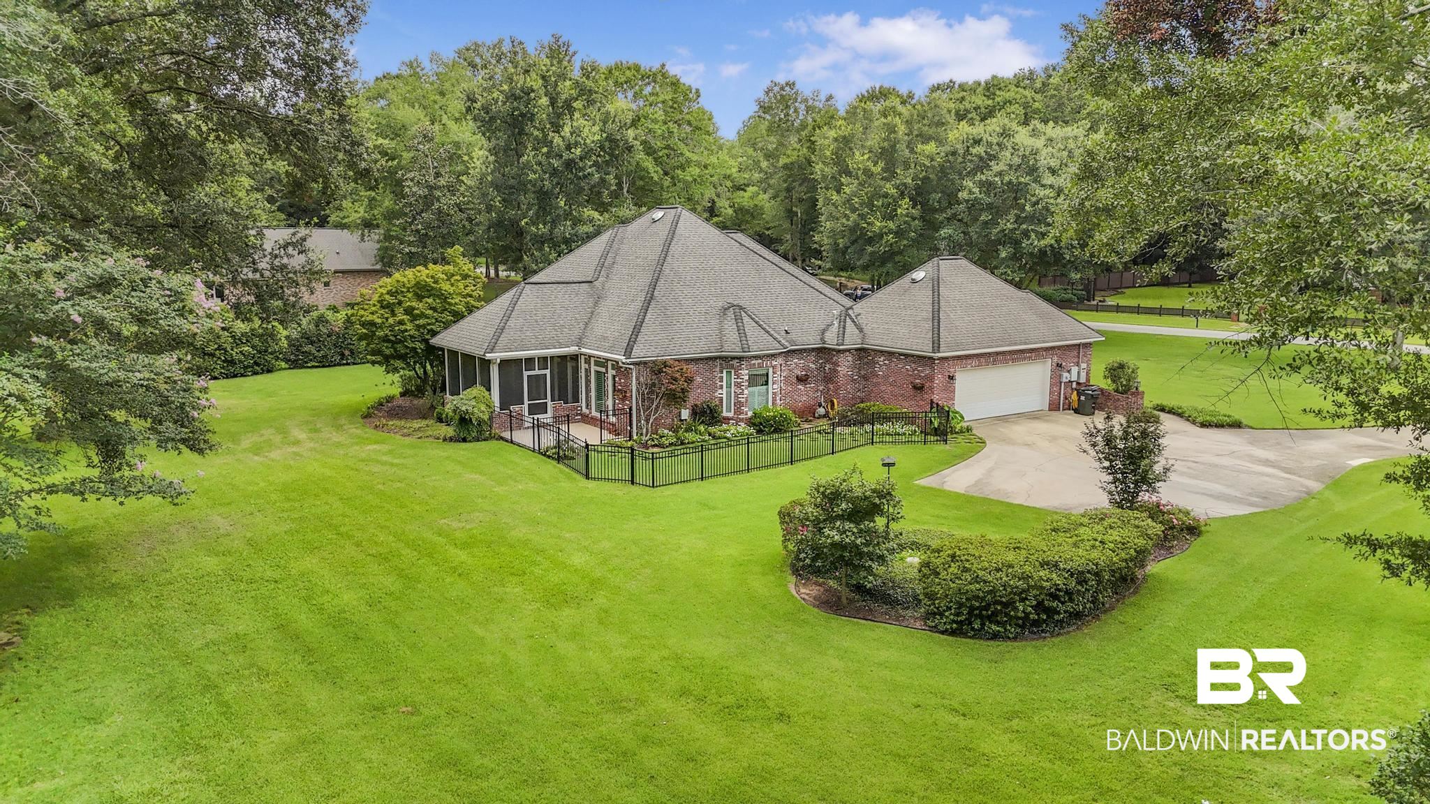 13612 Rue Royal Lane Silverhill, AL 36576 - Photo 58 of 65 View of front of home featuring brick siding, a garage, concrete driveway, and a shingled roof