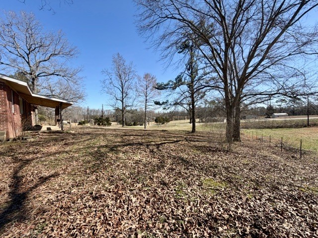 9554 Brooksie Thompson Road Bath Springs, TN 38311 - Photo 11 of 45 a view of yard covered with snow in front of house