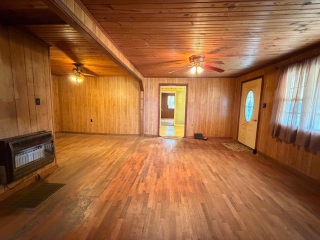 9554 Brooksie Thompson Road Bath Springs, TN 38311 - Photo 14 of 45 a view of an empty room with wooden floor and a kitchen