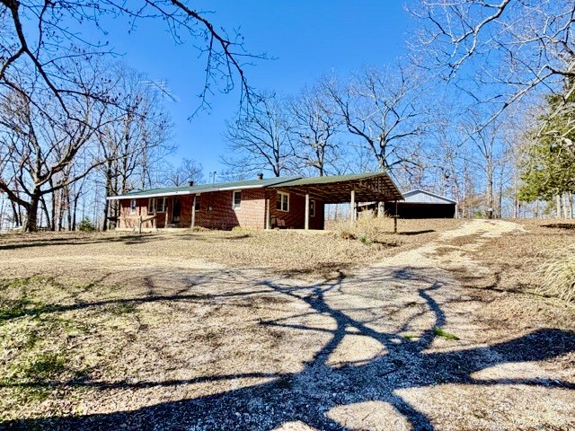 9554 Brooksie Thompson Road Bath Springs, TN 38311 - Photo 2 of 45 a front view of a house with large trees