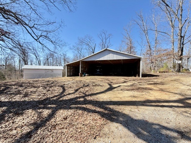 9554 Brooksie Thompson Road Bath Springs, TN 38311 - Photo 30 of 45 a view of a yard with an outdoor space