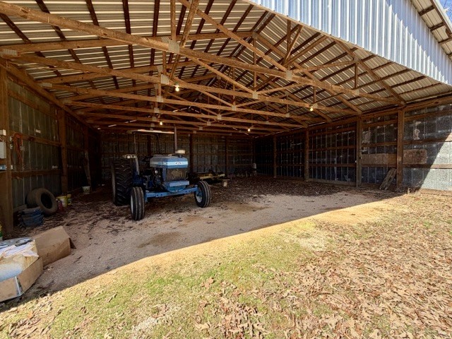 9554 Brooksie Thompson Road Bath Springs, TN 38311 - Photo 33 of 45 a view of a room with a wooden roof and a bed