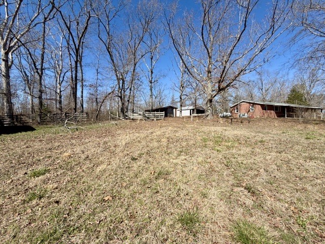 9554 Brooksie Thompson Road Bath Springs, TN 38311 - Photo 44 of 45 a view of a yard with wooden fence
