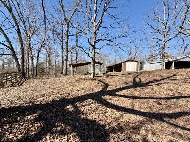 9554 Brooksie Thompson Road Bath Springs, TN 38311 - Photo 10 of 45 a view of house with snow on the road