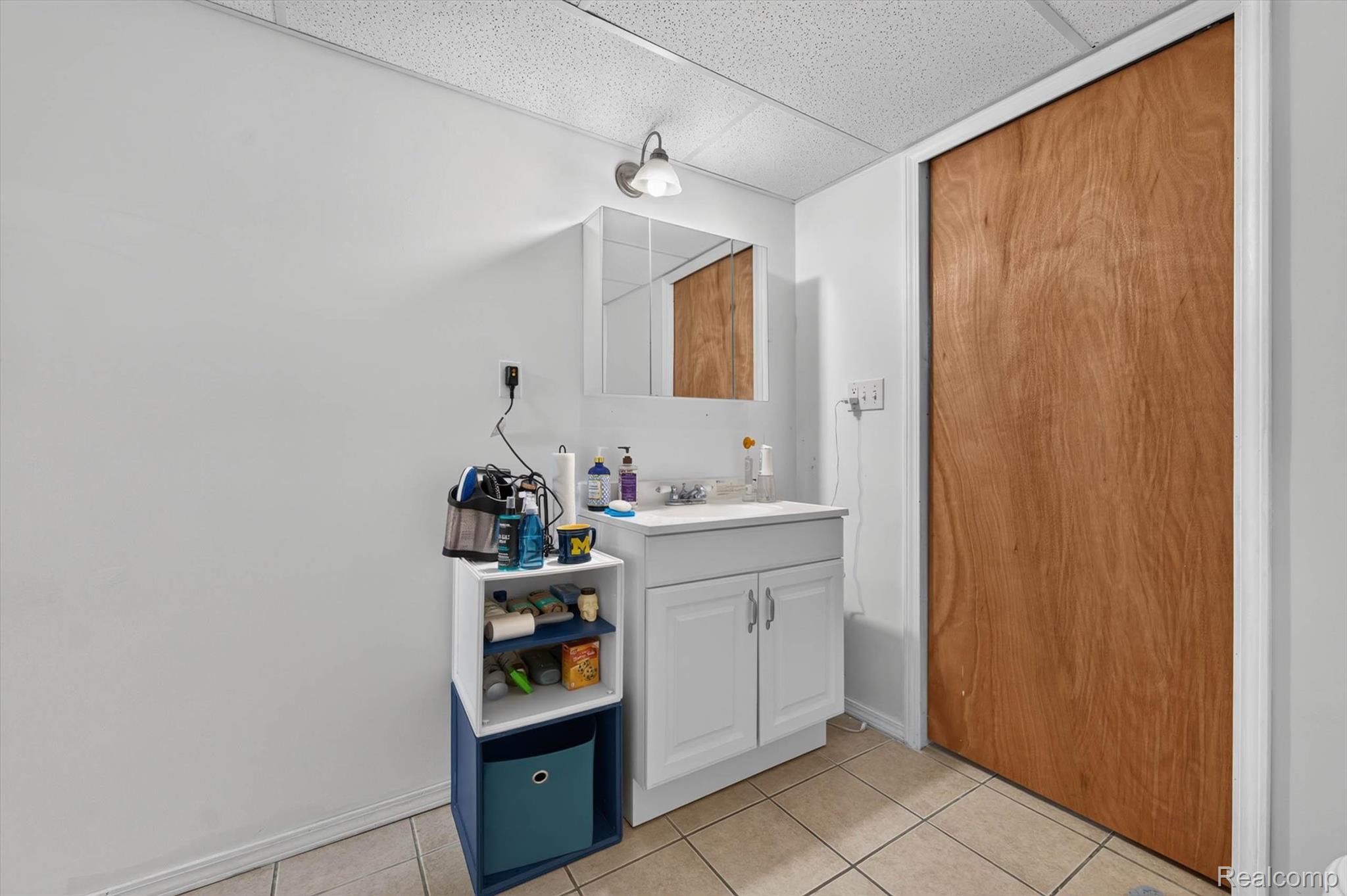 46362 Springhill Drive Utica, MI 48317 - Photo 35 of 59 White vanity with integrated sink, overhead wall-mounted light fixture, and mirrored medicine cabinet