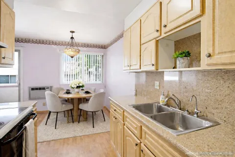 a kitchen with stainless steel appliances granite countertop a stove a refrigerator and a sink