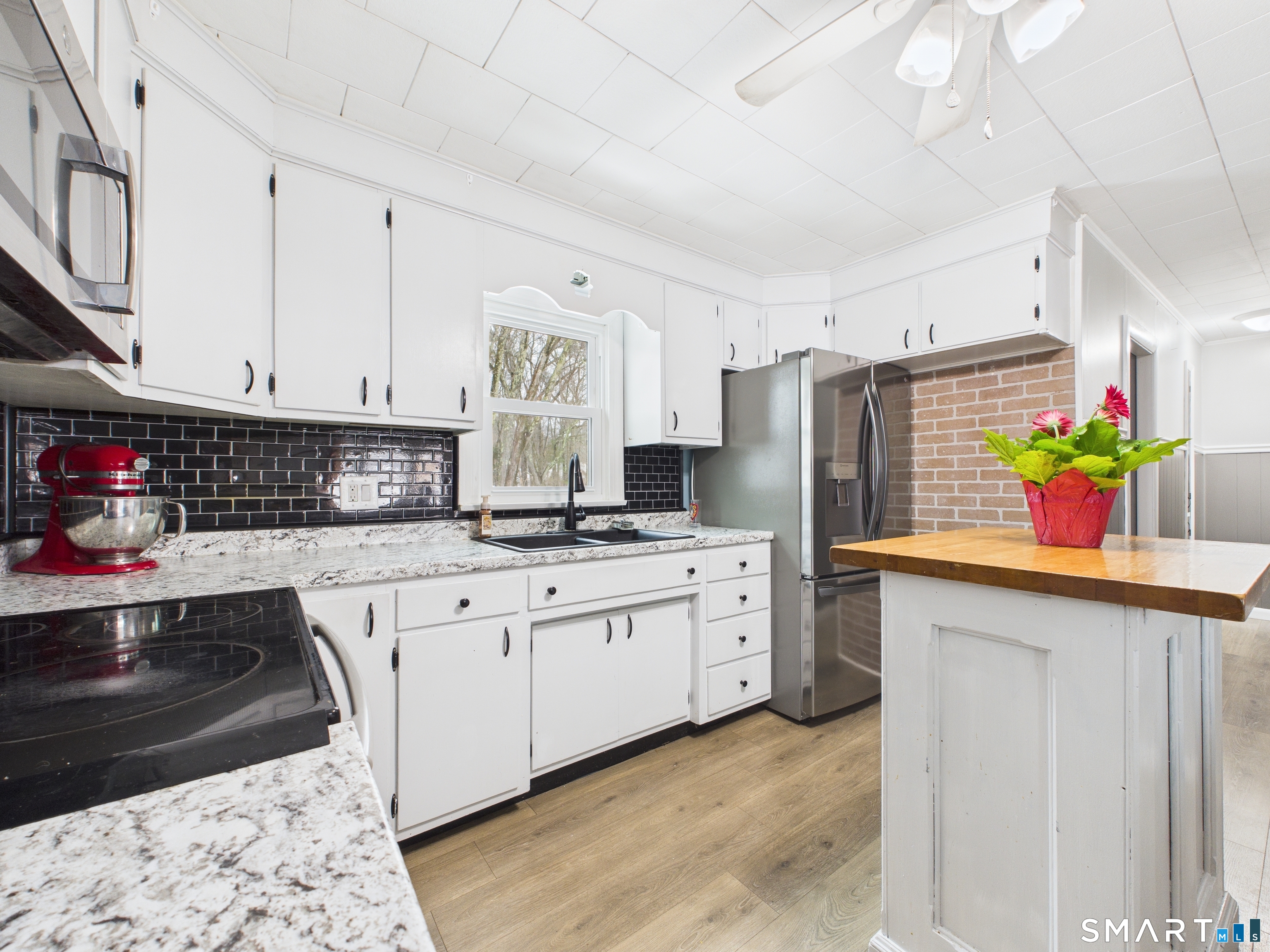 10 1st Street Thompson, CT 06255 - Photo 5 of 28 a kitchen with stainless steel appliances granite countertop a sink dishwasher and cabinets with wooden floor