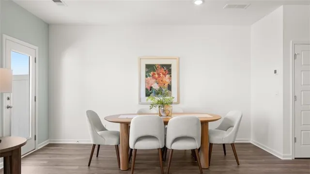 a dining room with furniture and wooden floor