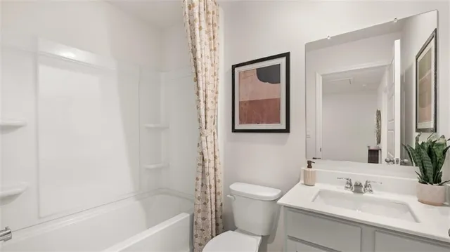a bathroom with a sink mirror toilet and bathtub