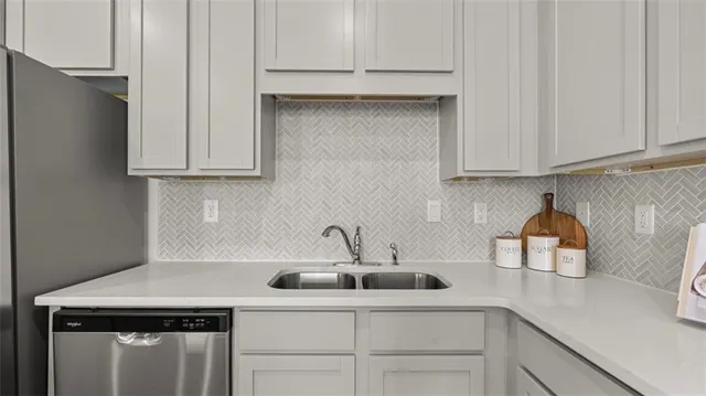 a kitchen with a sink cabinets and appliances