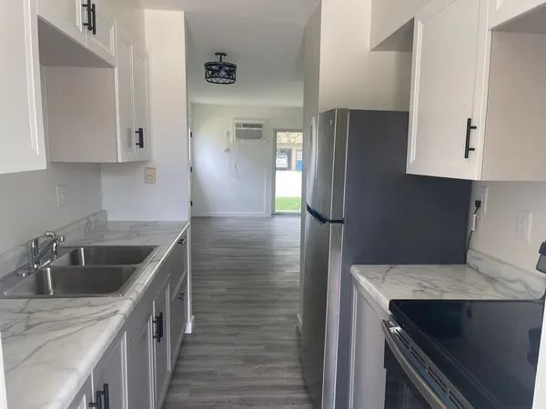 a kitchen with a sink and refrigerator