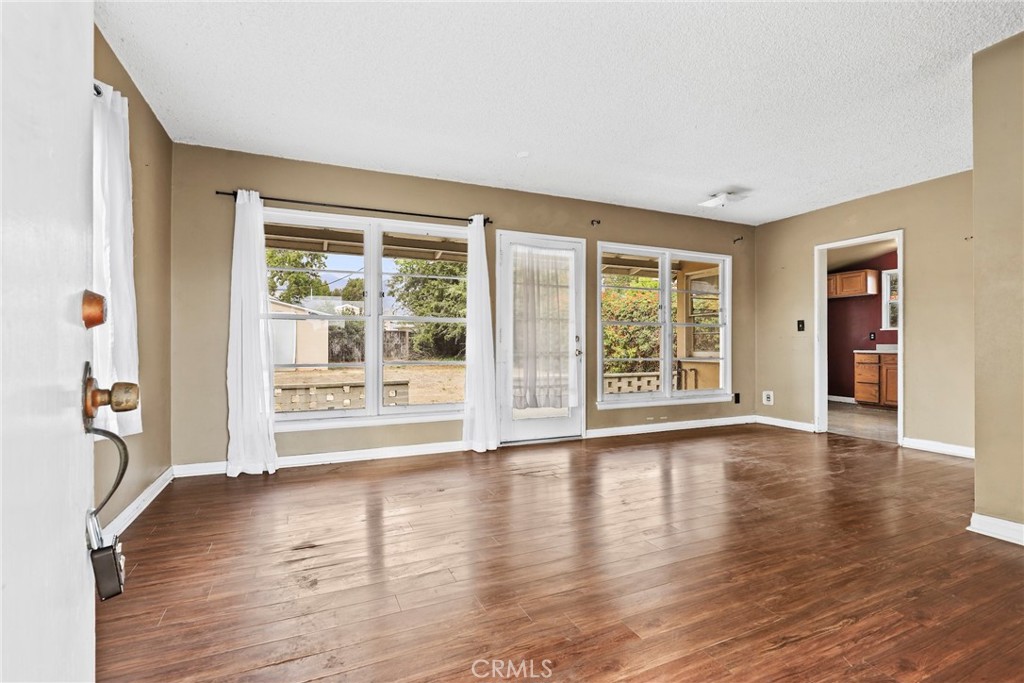 121 Shrode Avenue Monrovia, CA 91016 - Photo 3 of 23 a view of an empty room with wooden floor and a window