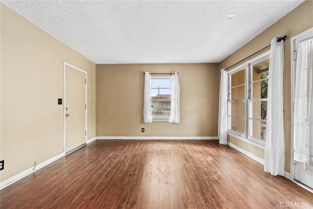 121 Shrode Avenue Monrovia, CA 91016 - Photo 5 of 23 an empty room with wooden floor and windows