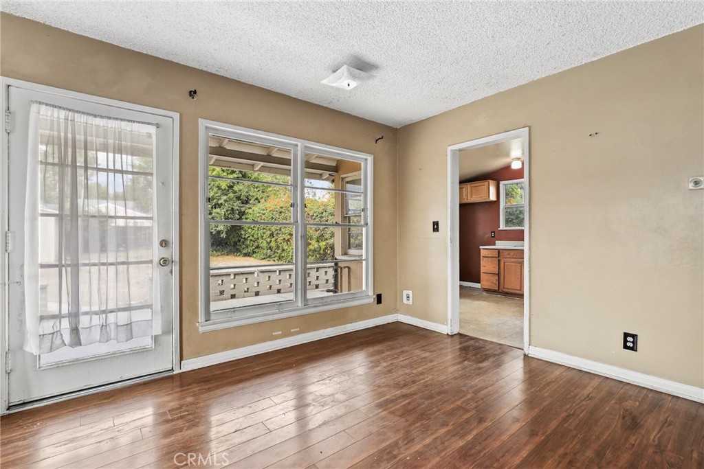 121 Shrode Avenue Monrovia, CA 91016 - Photo 6 of 23 a view of an empty room with wooden floor and a window