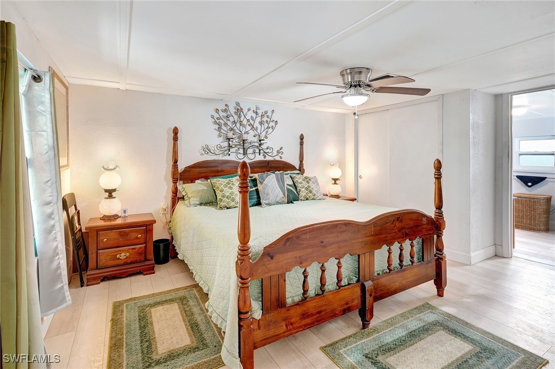 2153 Twin Brooks Road North Fort Myers, FL 33917 - Photo 13 of 31 a bedroom with a bed a chandelier and dresser