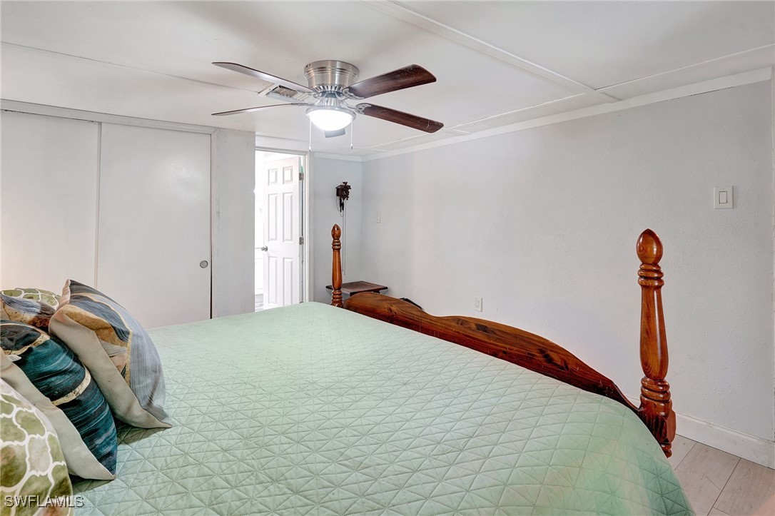 2153 Twin Brooks Road North Fort Myers, FL 33917 - Photo 14 of 31 a bedroom with a bed and a chandelier