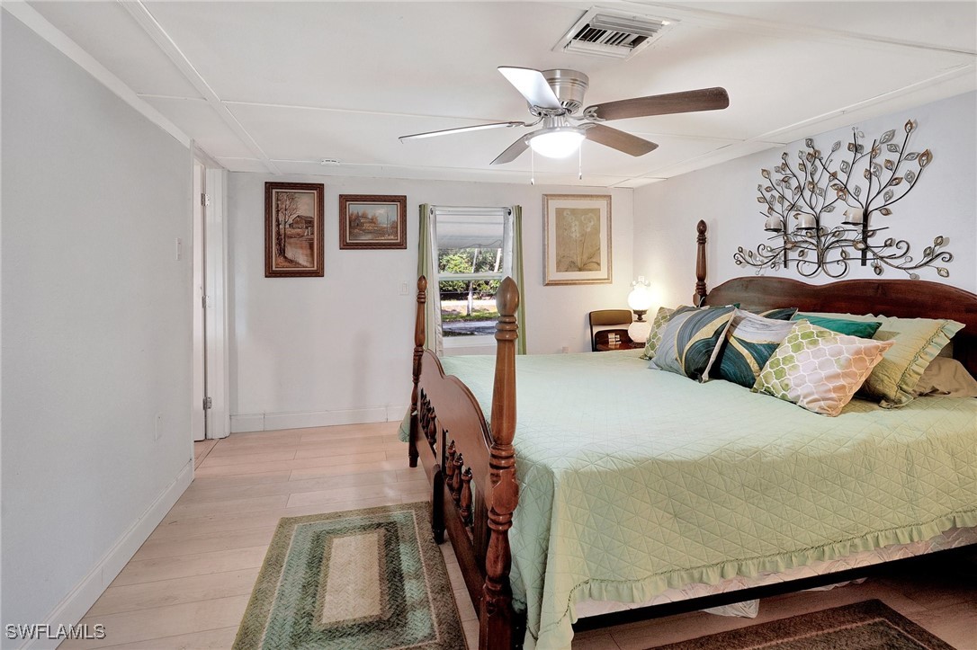 2153 Twin Brooks Road North Fort Myers, FL 33917 - Photo 15 of 31 a bedroom with a bed and a chandelier