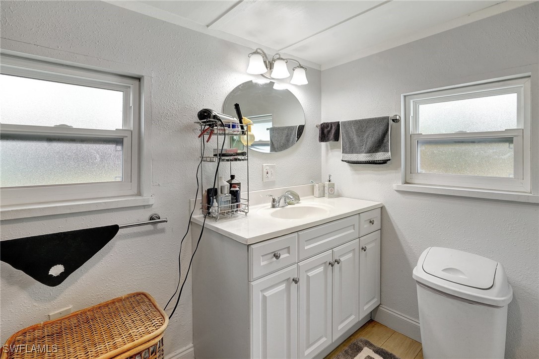2153 Twin Brooks Road North Fort Myers, FL 33917 - Photo 17 of 31 a bathroom with a sink a toilet a mirror and window
