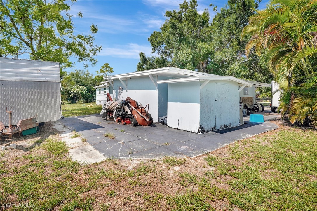 2153 Twin Brooks Road North Fort Myers, FL 33917 - Photo 26 of 31 a view of a house with a yard and large tree