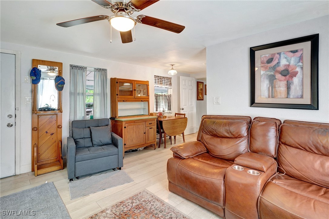 2153 Twin Brooks Road North Fort Myers, FL 33917 - Photo 9 of 31 a living room with furniture and a chandelier