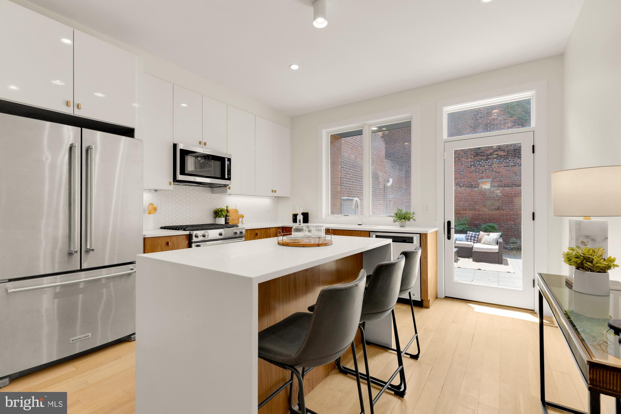 419 Independence Avenue Southeast Washington, DC 20003 - Photo 11 of 32 a kitchen that has a lot of cabinets a sink and a refrigerator