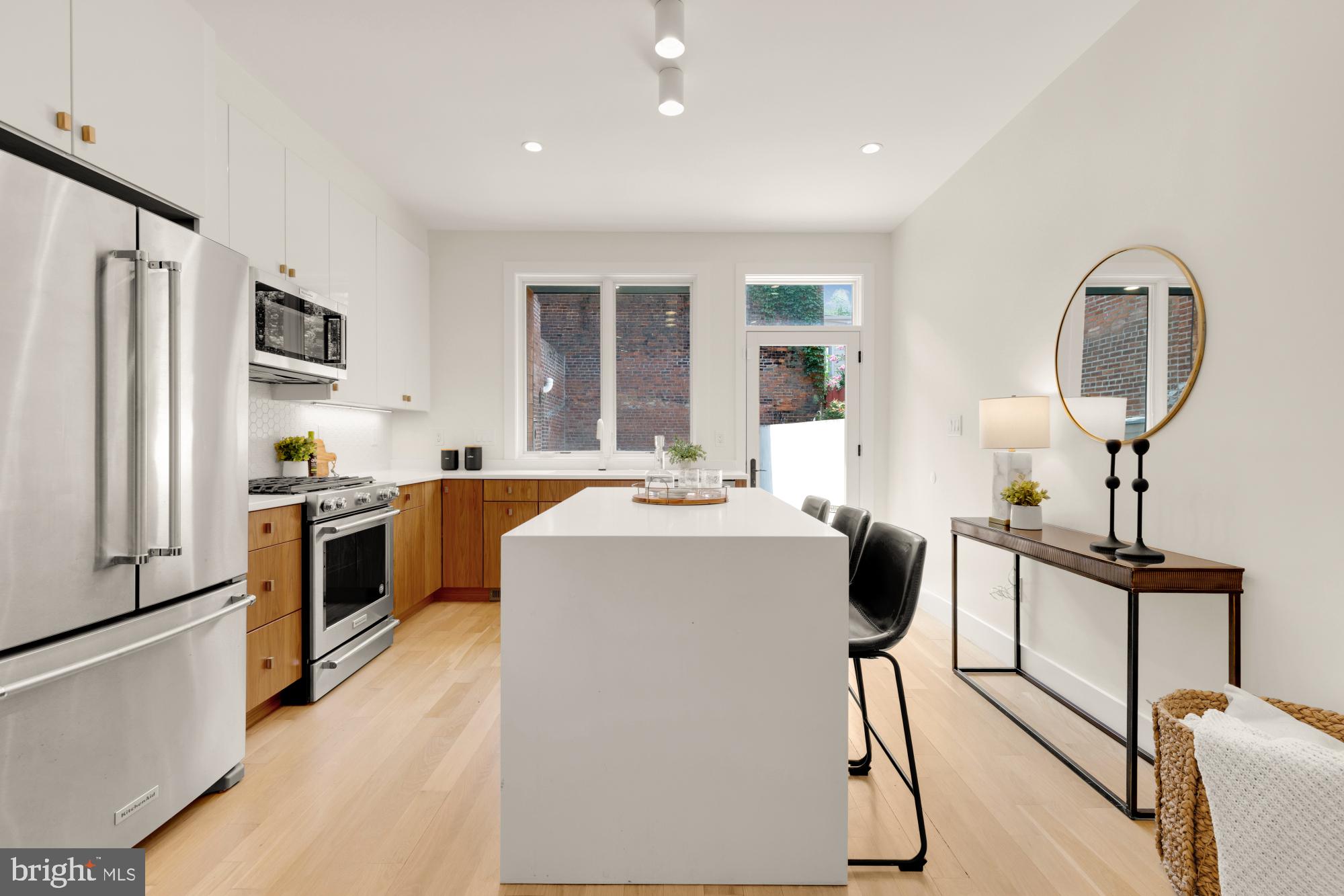 419 Independence Avenue Southeast Washington, DC 20003 - Photo 12 of 32 a kitchen with kitchen island a stove a sink and a refrigerator