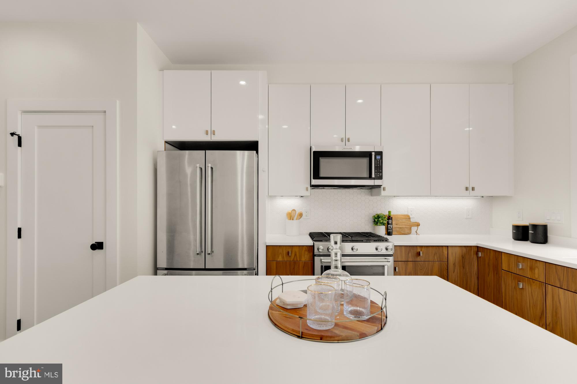 419 Independence Avenue Southeast Washington, DC 20003 - Photo 13 of 32 a kitchen with stainless steel appliances a refrigerator a sink a stove and white cabinets
