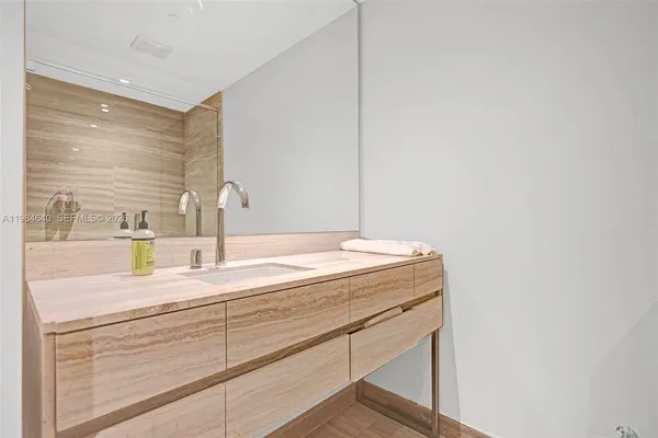 a bathroom with a sink and a mirror