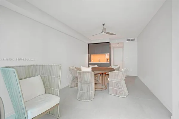 a living room with furniture a flat screen tv and a window