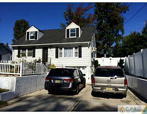 128 Raritan Boulevard Old Bridge, NJ 07735 - Photo 2 of 15 a car parked in front of a white house