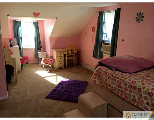 128 Raritan Boulevard Old Bridge, NJ 07735 - Photo 11 of 15 a bedroom with furniture and a window