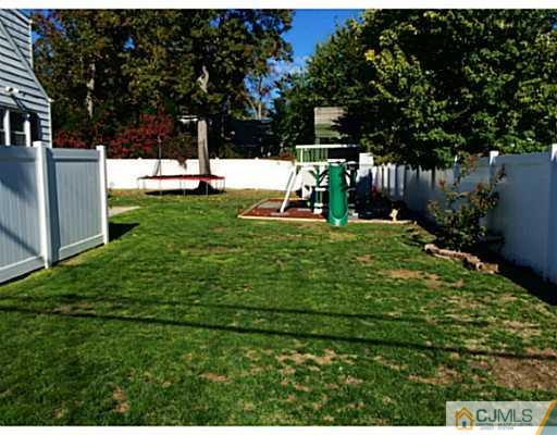 128 Raritan Boulevard Old Bridge, NJ 07735 - Photo 14 of 15 a view of a backyard with large trees